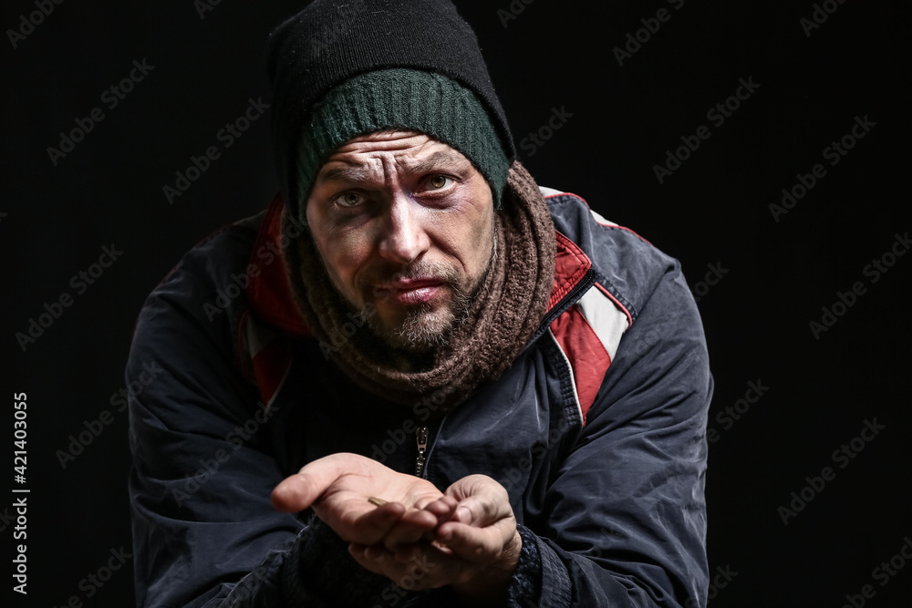 Portrait of poor homeless man on dark background Portrait of poor homeless man on dark background