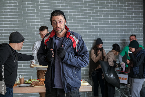 Poor homeless man in warmin...