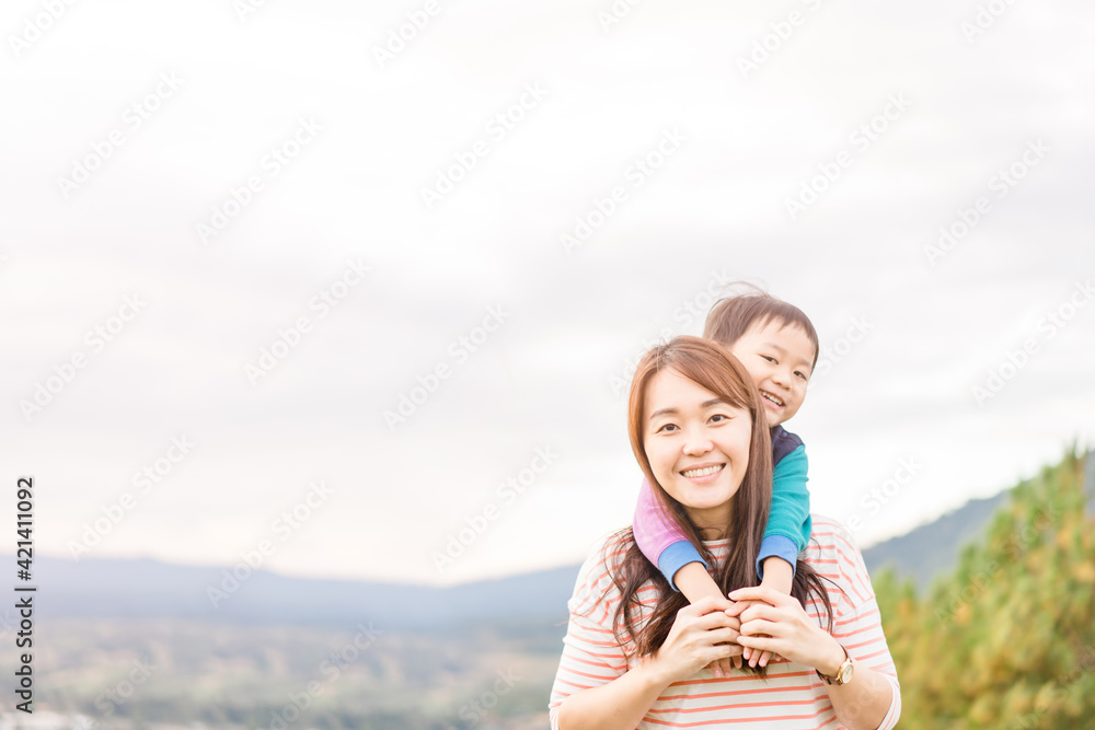 Portrait of asian mother and toddler boy child playing having fun.Travel Happy son and mom laughing hugging in playground outdoor.family asian korean mom.Mother’s day holiday.People mother child.