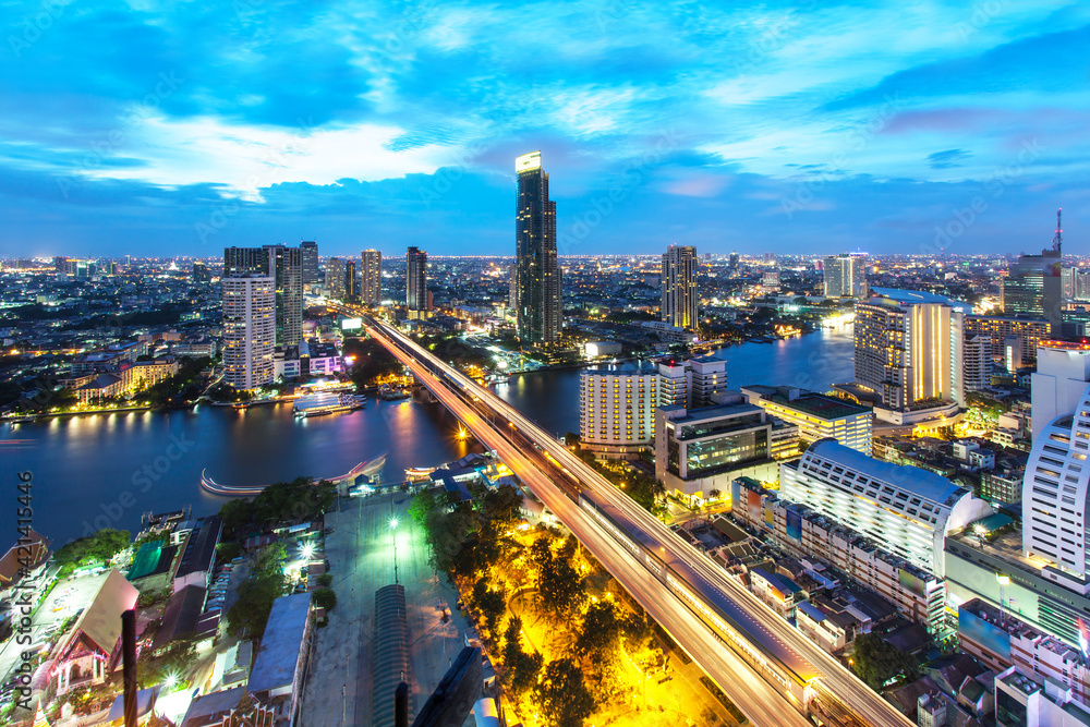Bangkok Transportation at Dusk with Modern Business Building along the river (Thailand)