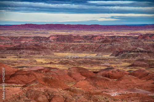 dramatic landscape photo of the Painted Desert in the Petrified Forest National Park in Arizona. The Painted Desert is known for its brilliant and varied colors.