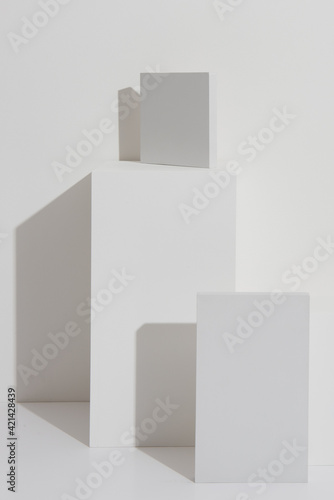 Plain white and grey blocks with shadows. Plinths for display.