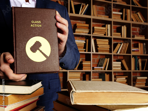 Foto CLASS ACTION book in the hands of a lawyer