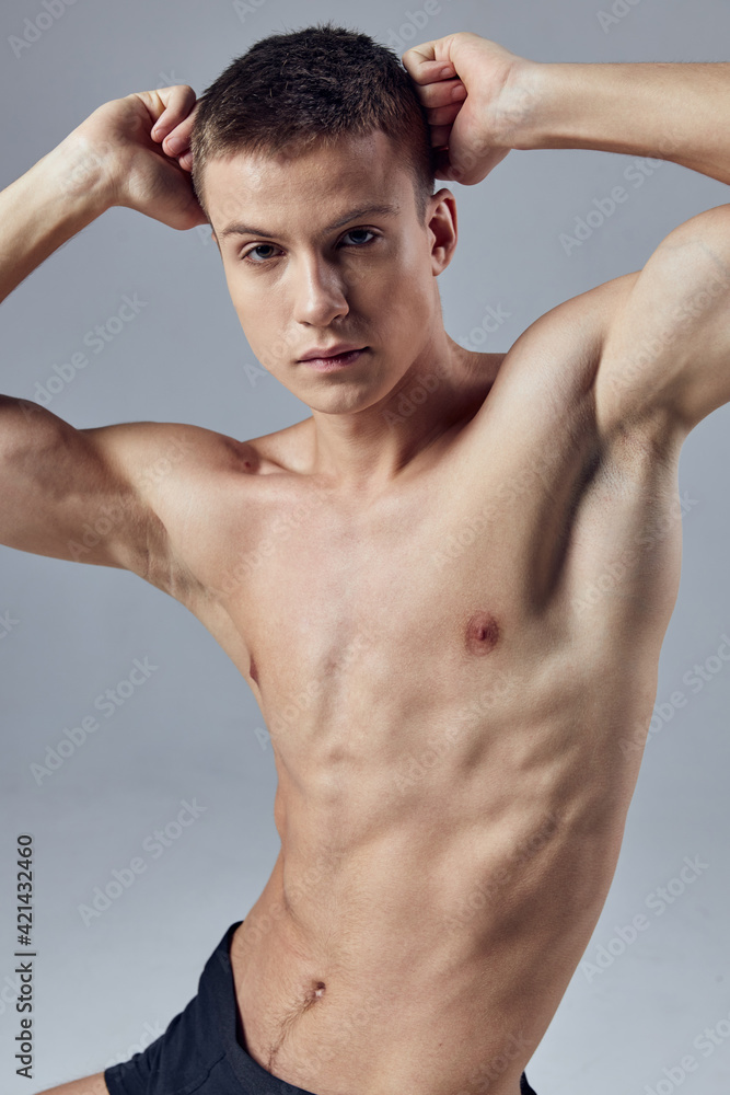 an athletic man holds his hands near his head, an inflated torso an athletic man holds his hands near his head, an inflated torso