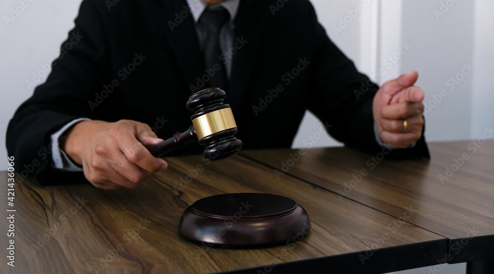 Lawyer Legal counsel presents to the client a signed contract with gavel and legal law. justice and lawyer Business partnership meeting concept. Lawyer Legal counsel presents to the client a signed contract with gavel and legal law. justice and lawyer Business partnership meeting concept.