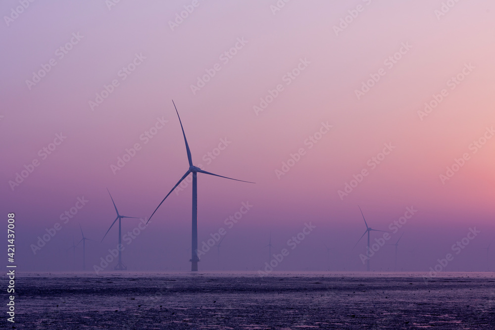 Wind turbines along the coastline in the morning
