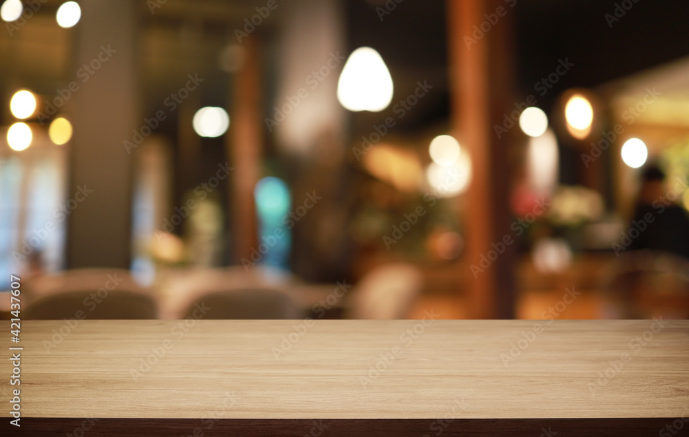 Empty wooden table in front of abstract blurred background of coffee shop . can be used for display or montage your products.Mock up for display of product Empty wooden table in front of abstract blurred background of coffee shop . can be used for display or montage your products.Mock up for display of product