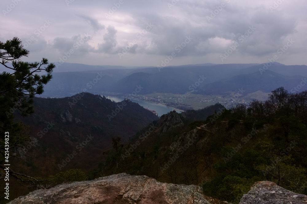 standing at a viewpoint with rocks with view to a wide landscape standing at a viewpoint with rocks with view to a wide landscape