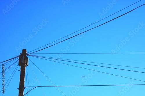 Low Angle View Of Power Lines Against Clear Blue Sky