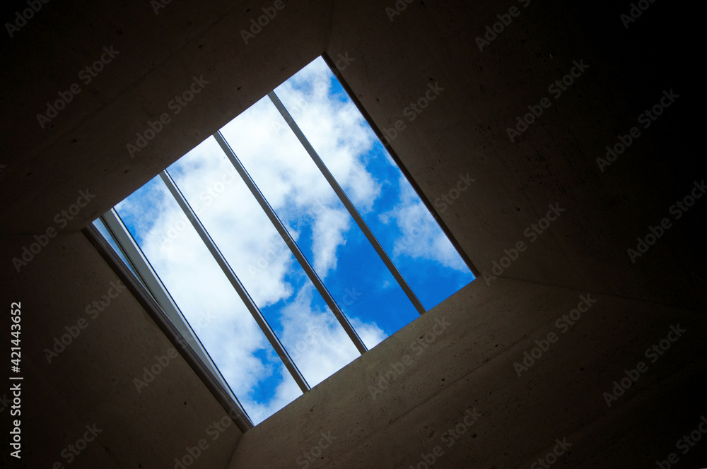 Prison window with grille overlooking beautiful blue sky with clouds Prison window with grille overlooking beautiful blue sky with clouds