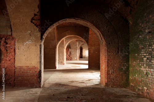 Perspective view of dark tunnel with an arched brick ceiling in old abandoned