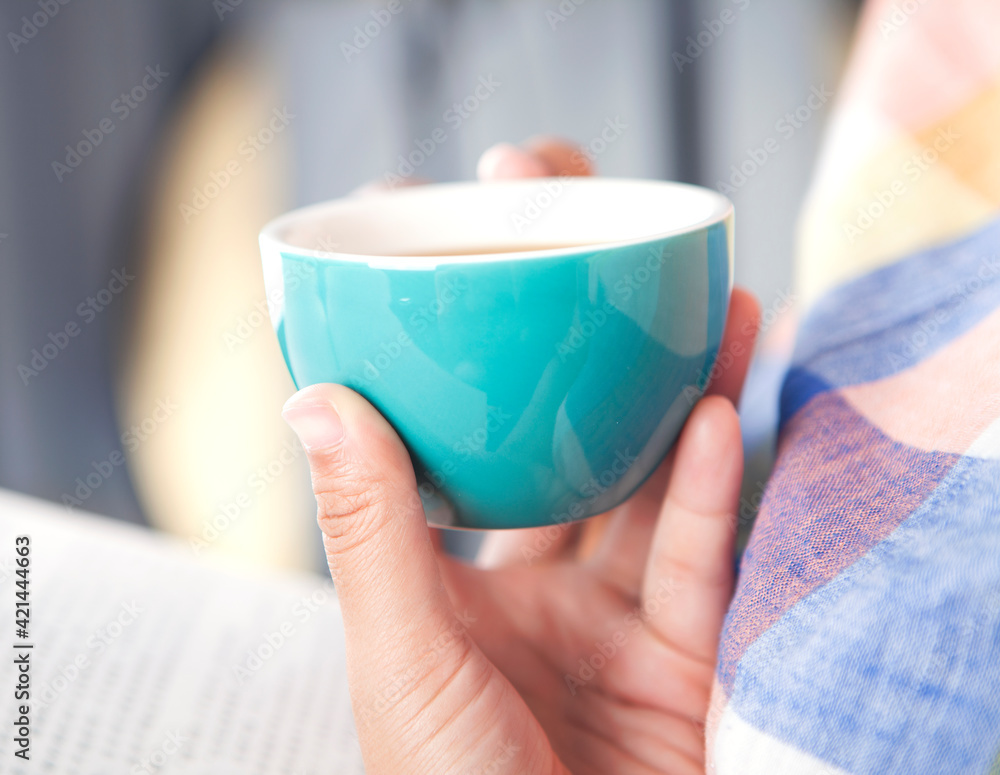 Holding a cup of coffee Holding a cup of coffee