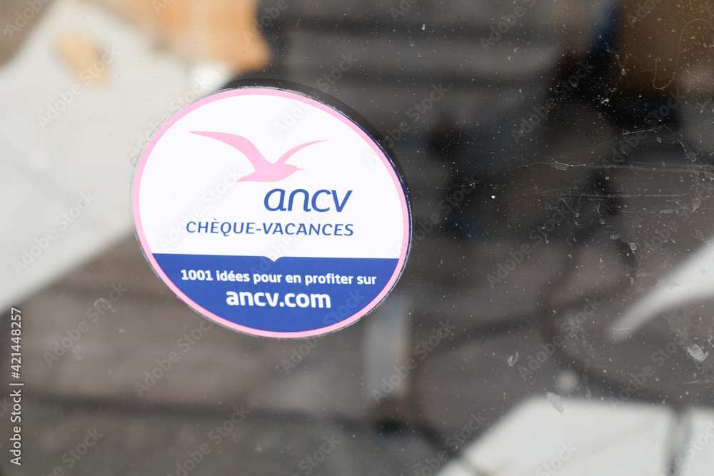 cheque vacances by ancv logo brand and text sign sticker on windows hotel  restaurant french label holiday departure aid Stock Photo | Adobe Stock