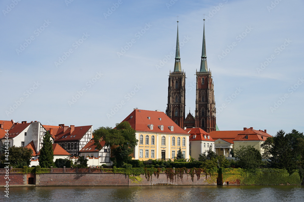 Wroclaw Cathedral of St. John the Baptist with two towers behind Oder River view, popular tourist destination, guided tour concept