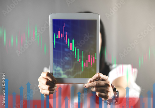 Investor and trader concept - investor with tablet and tradeview graph and marketting reports on tablet screens in his modern. photo