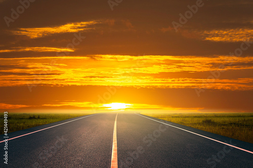 road and grassland at countryside at sunset