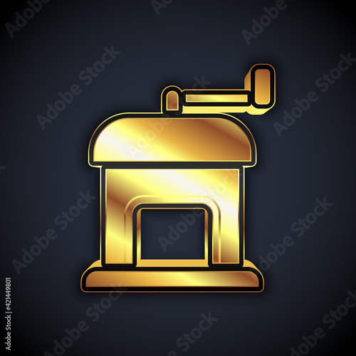 Gold Manual coffee grinder icon isolated on black background. Vector