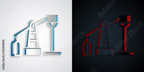 Paper cut Oil pump or pump jack icon isolated on grey and black background. Oil rig. Paper art style. Vector