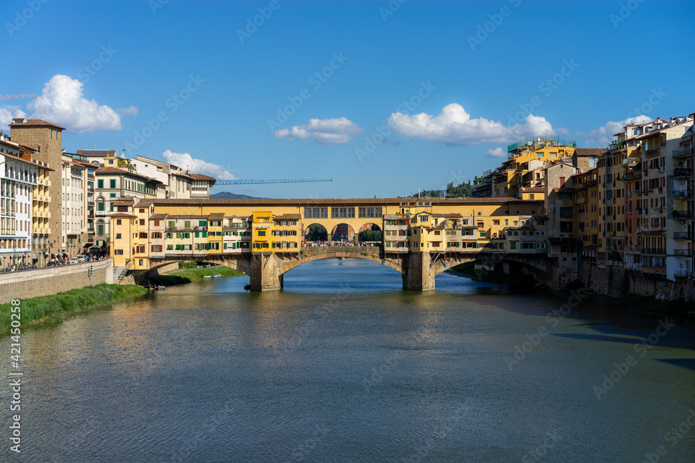 The Ponte Vecchio, the old bridge with its reflection in the Arno river  in Firenze, Florence, Italy