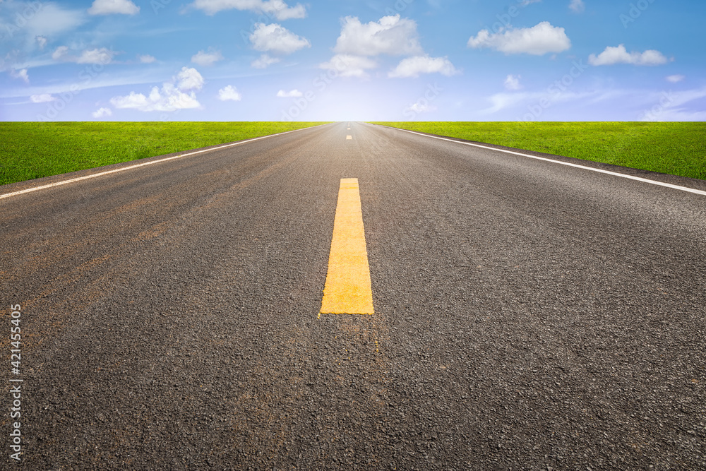 Fototapeta premium Highway in perspective view and nature landscape. Consist of long straight line on asphalt road or way and empty horizon sky background at outdoor or countryside. Concept for trip, journey and freedom