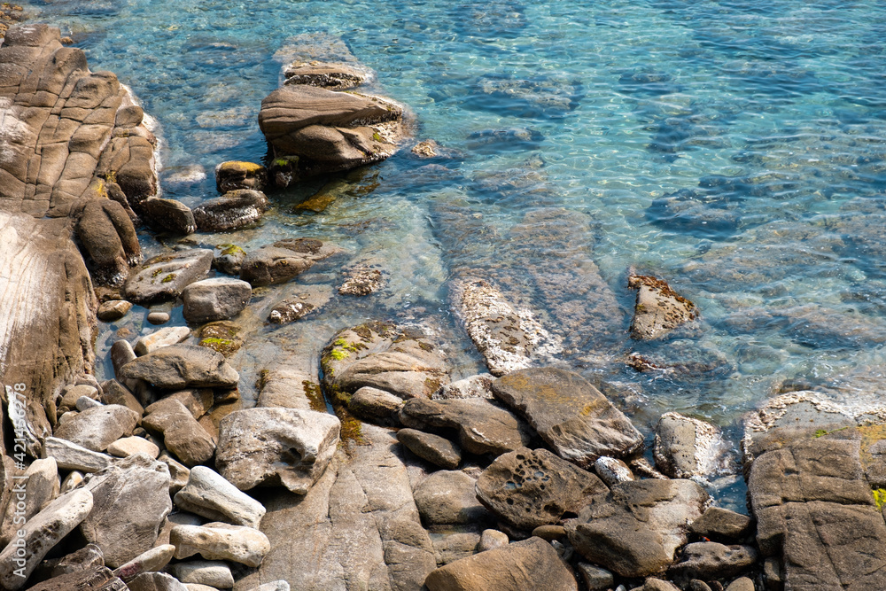 Rocky beach with calm beautiful sea at sunny day. Greece Rocky beach with calm beautiful sea at sunny day. Greece