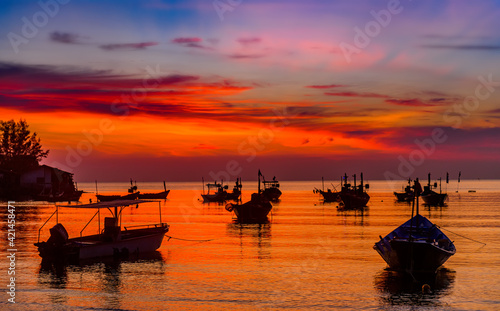 Silhouette fishery boats in the sunset time.