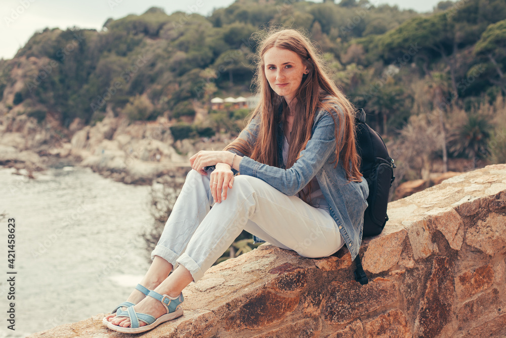 woman sitting on a rock in spain