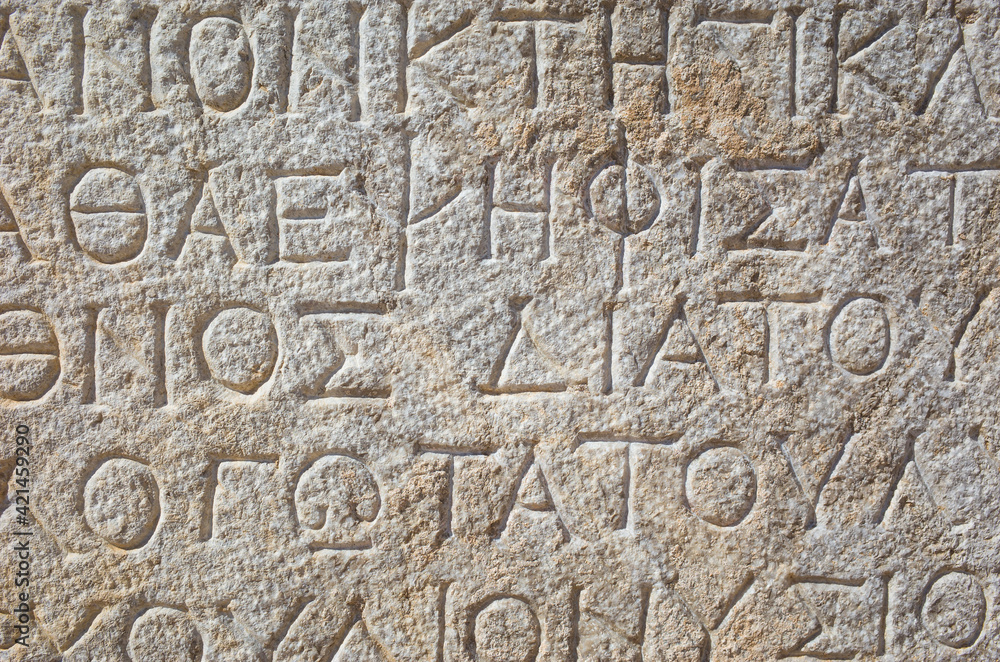 Ancient greek writing on stone in ancient city of Patara, Turkey. Close up detail