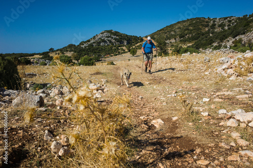 Hiking Lycian way. Man and dog trekking on Lycian Way trail on stretch between Kalkan and Kas, Trekking in Turkey, outdoor activity