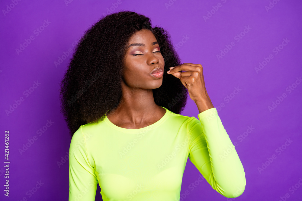 Photo of young beautiful pretty african girl trying enjoying food wear sportive suit isolated on violet color background Photo of young beautiful pretty african girl trying enjoying food wear sportive suit isolated on violet color background