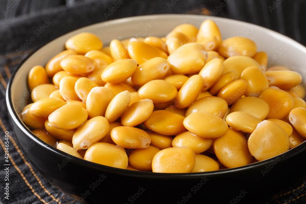 Traditional appetizer lupine beans close-up in a bowl on the table. horizontal Traditional appetizer lupine beans close-up in a bowl on the table. horizontal
