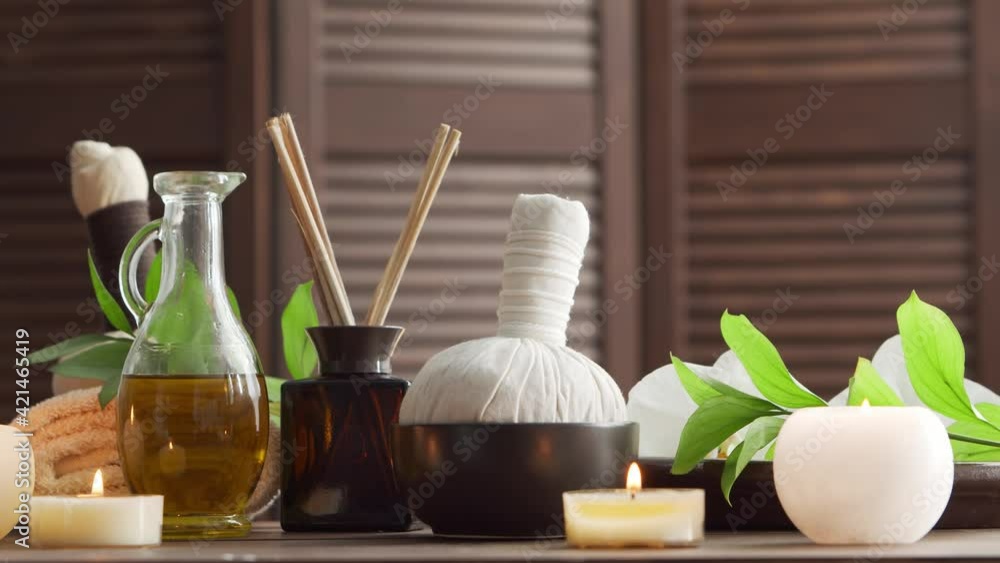 Spa background. Towel, candles, flowers, massaging stones and herbal balls. Massage, oriental therapy, wellbeing and meditation. Spa background. Towel, candles, flowers, massaging stones and herbal balls. Massage, oriental therapy, wellbeing and meditation.