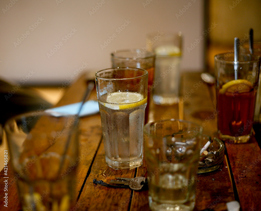 glass of lemon tea and cocktail glass of lemon tea and cocktail