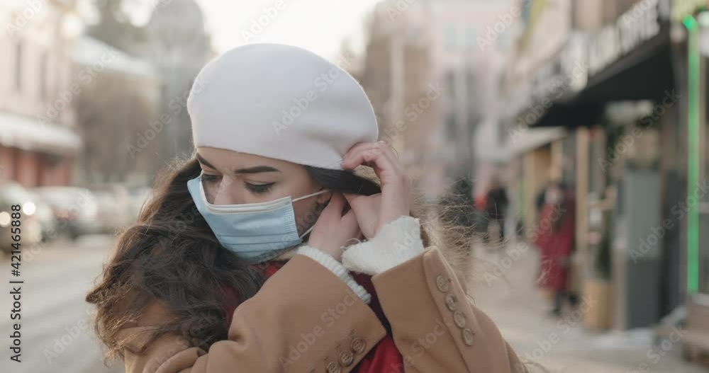 a beautiful young girl puts on a mask and urges people to take care of themselves and fight the pandemic a beautiful young girl puts on a mask and urges people to take care of themselves and fight the pandemic
