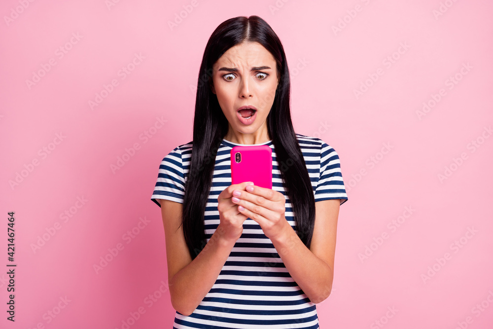 Close-up portrait of lovely worried desperate girl using gadget browsing media fake news isolated on pink pastel color background Close-up portrait of lovely worried desperate girl using gadget browsing media fake news isolated on pink pastel color background