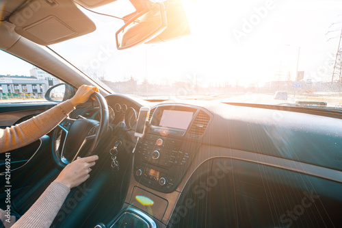 Road trip. Happy young woman have fun travel inside car at sunset. winter vacation concept with driver. © Maksym