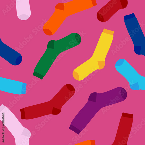 Multi-colored socks on a pink background seamless pattern. View from above. Many different socks for cold seasons. Socks are scattered on a bright background.