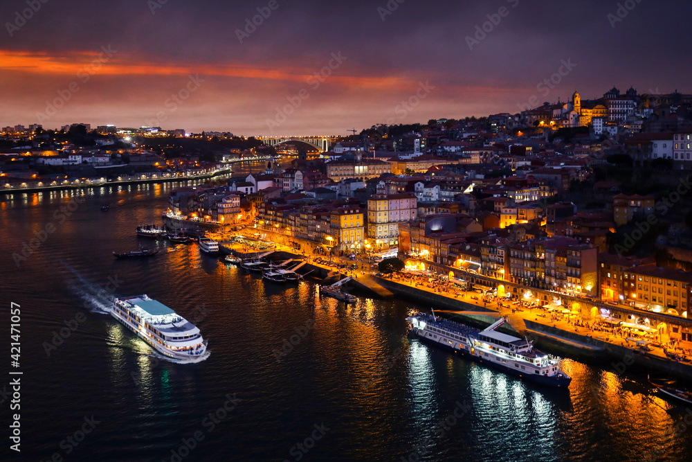 Porto at dusk. View of the center of Porto and the Duoro River at night against a sunset