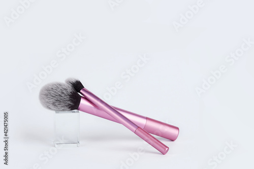 A bunch of make-up brushes isolated on a white background.