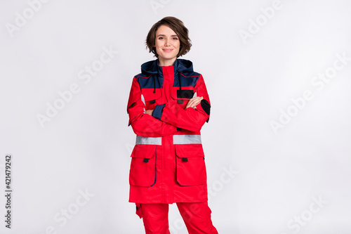 Photo of optimistic nice brunette lady crossed arms wear uniform isolated on grey color background photo