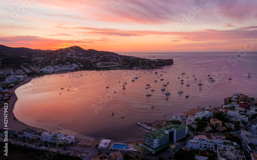 Stunning sunset in Ibiza Spain with orange sky and boats floating on the sea