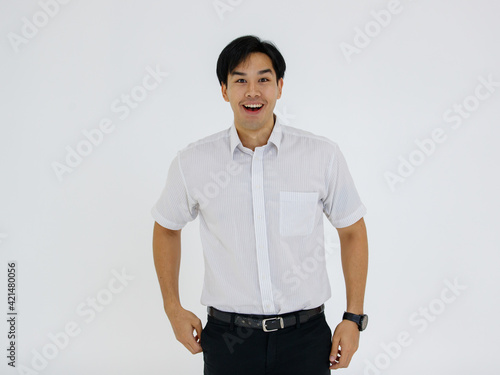 Portrait of Asian young and handsome businessman in casual shirt and slack trousers posing in advertising gesture with friendly and positive isolated on white background © Bangkok Click Studio