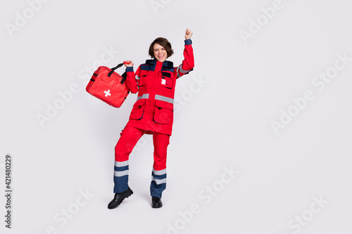Full size photo of hooray nice brunette lady with bag hands fists wear uniform isolated on grey color background