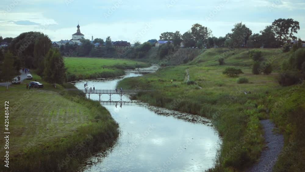 Panoramic view of the Kamenka river and the walls of the monastery in Suzdal, Russia. Panoramic view of the Kamenka river and the walls of the monastery in Suzdal, Russia.