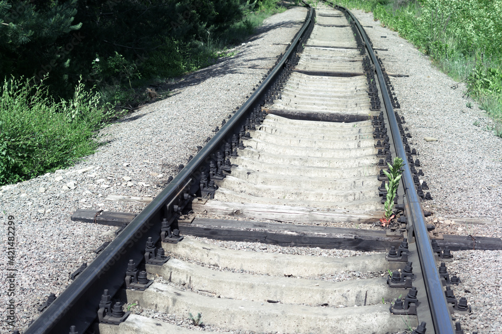 well-maintained railway track for non-passenger special purposes. Steel rails on concrete sleepers. elongated wooden sleepers are installed to distribute heavy cargo load