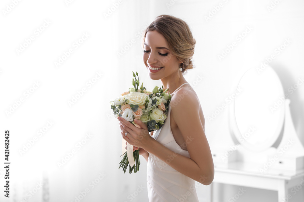 Young bride with beautiful wedding bouquet in room Young bride with beautiful wedding bouquet in room