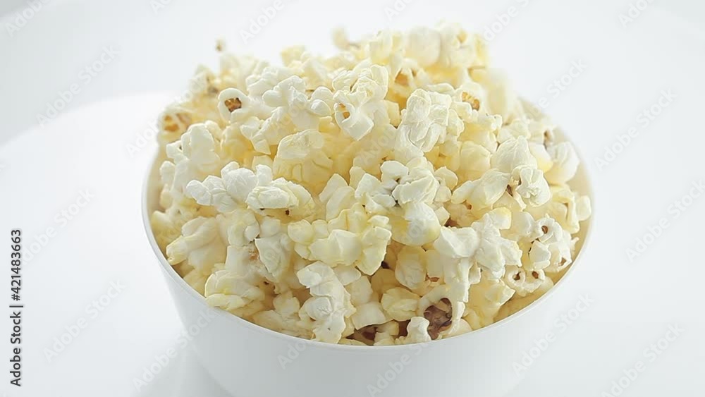 Popcorn salted corn, cooked, in white, bowl, rotation clockwise, turning. Popcorn salted corn, cooked, in white, bowl, rotation clockwise, turning.