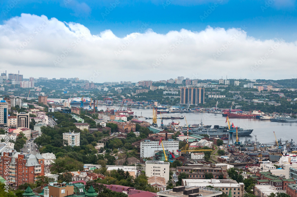 Cityscape panorama of Vladivostok downtown and Zolotoy Rog (Golden Horn Bay) from the top of the Eagle's Nest hill on a sunny day