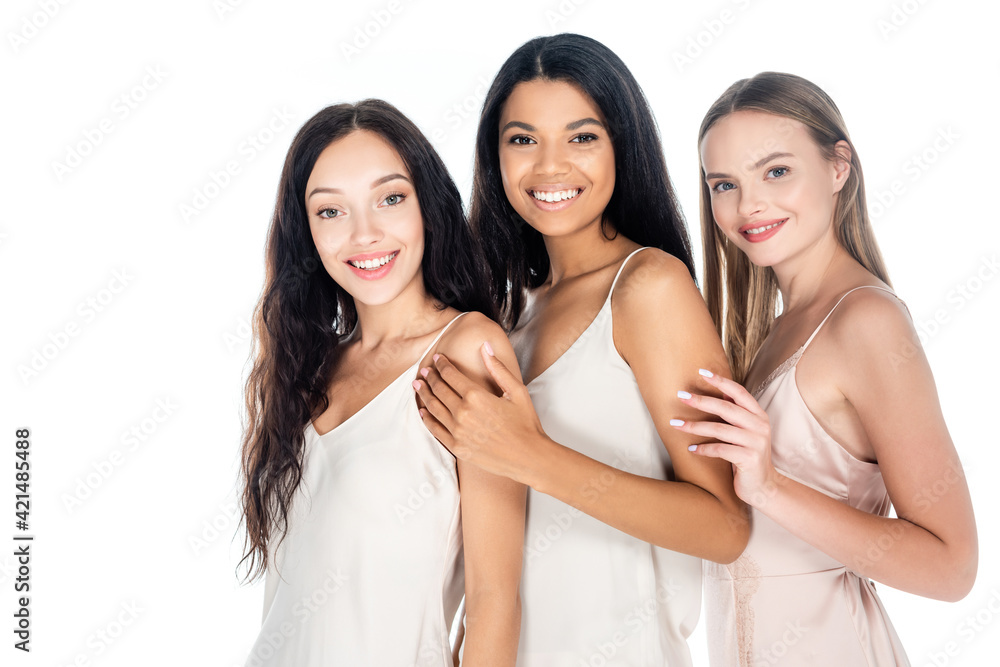 joyful interracial women in dresses smiling isolated on white joyful interracial women in dresses smiling isolated on white