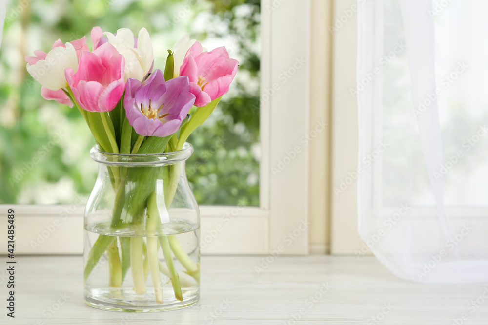 Beautiful fresh tulips on window sill indoors. Spring flowers Beautiful fresh tulips on window sill indoors. Spring flowers